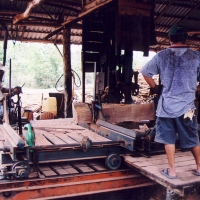 The bottom wheel of this giant bandsaw is below the deck here. This gent often has to climb down and shovel out the sawdust