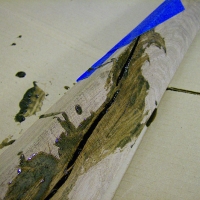 Working with epoxy is a rather messy job. Blue masking tape on the back side of the boards helped force the epoxy to build up inside the crack rather than run out.