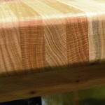 Close up showing basic butcher block construction. Made up of 3/4" thick red oak cut to 1-3/4" wide, turned on edge and glued together