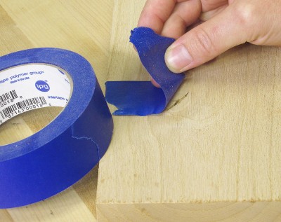 If the knots or cracks go all the way through your board, flip it over and cover the backside of the void with masking tape. This helps prevent a nasty mess leaking through, or worse your board getting glued to your workbench.